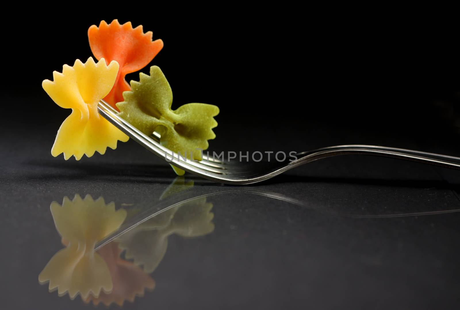 Reflexion of pasta farfalle on a fork