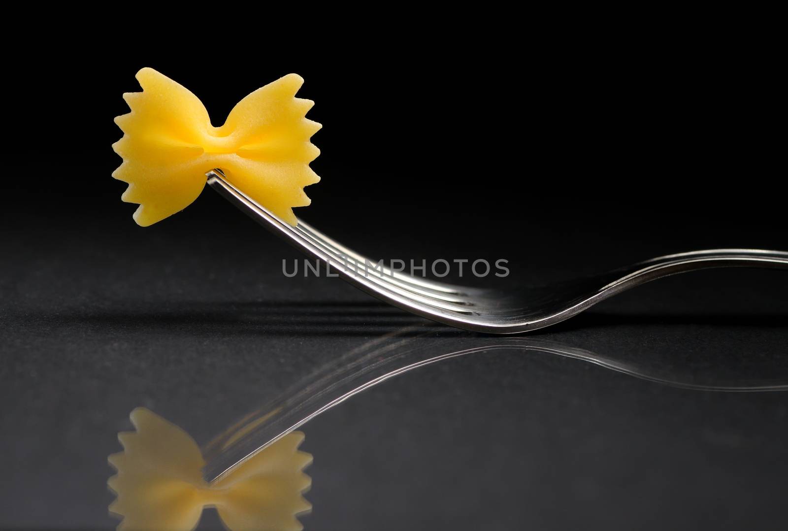 Reflexion of pasta farfalle on a fork