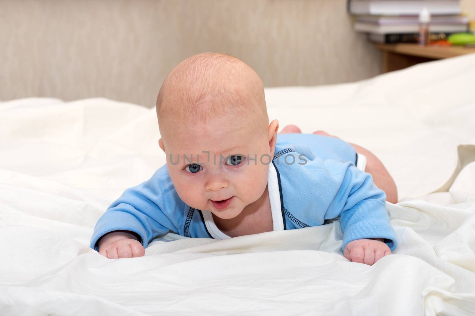 Indoor close up shot of boy lying on stomach