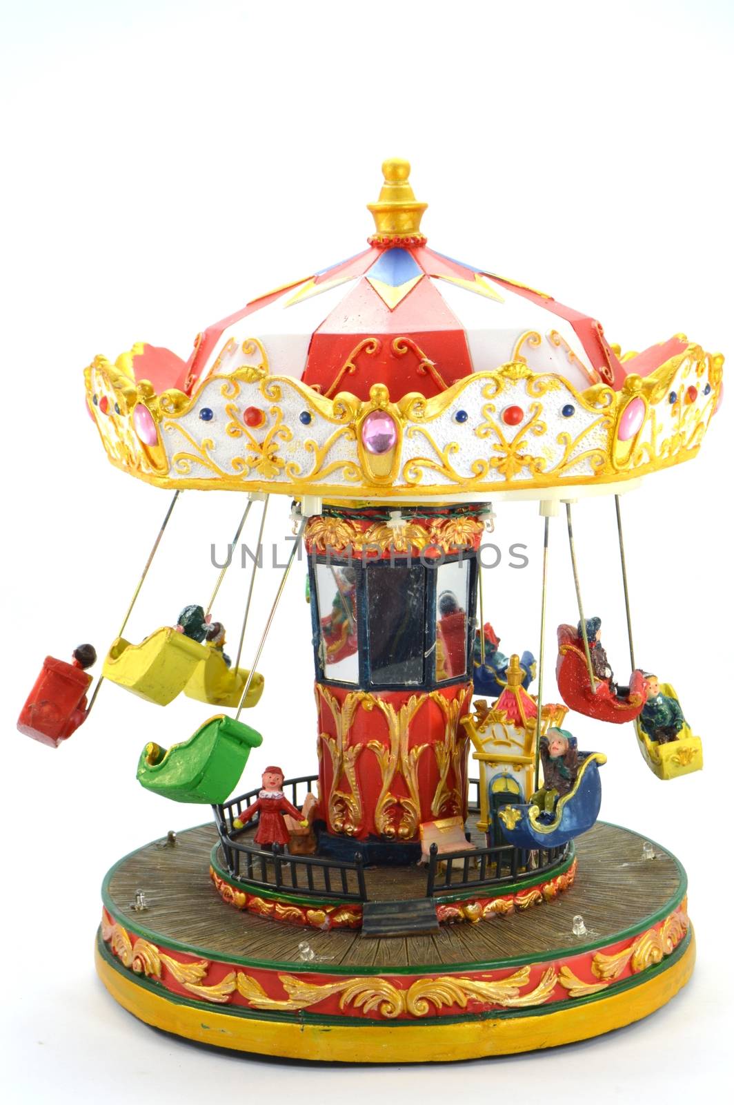 Wooden carousel of Christmas with small seats and lively colors.