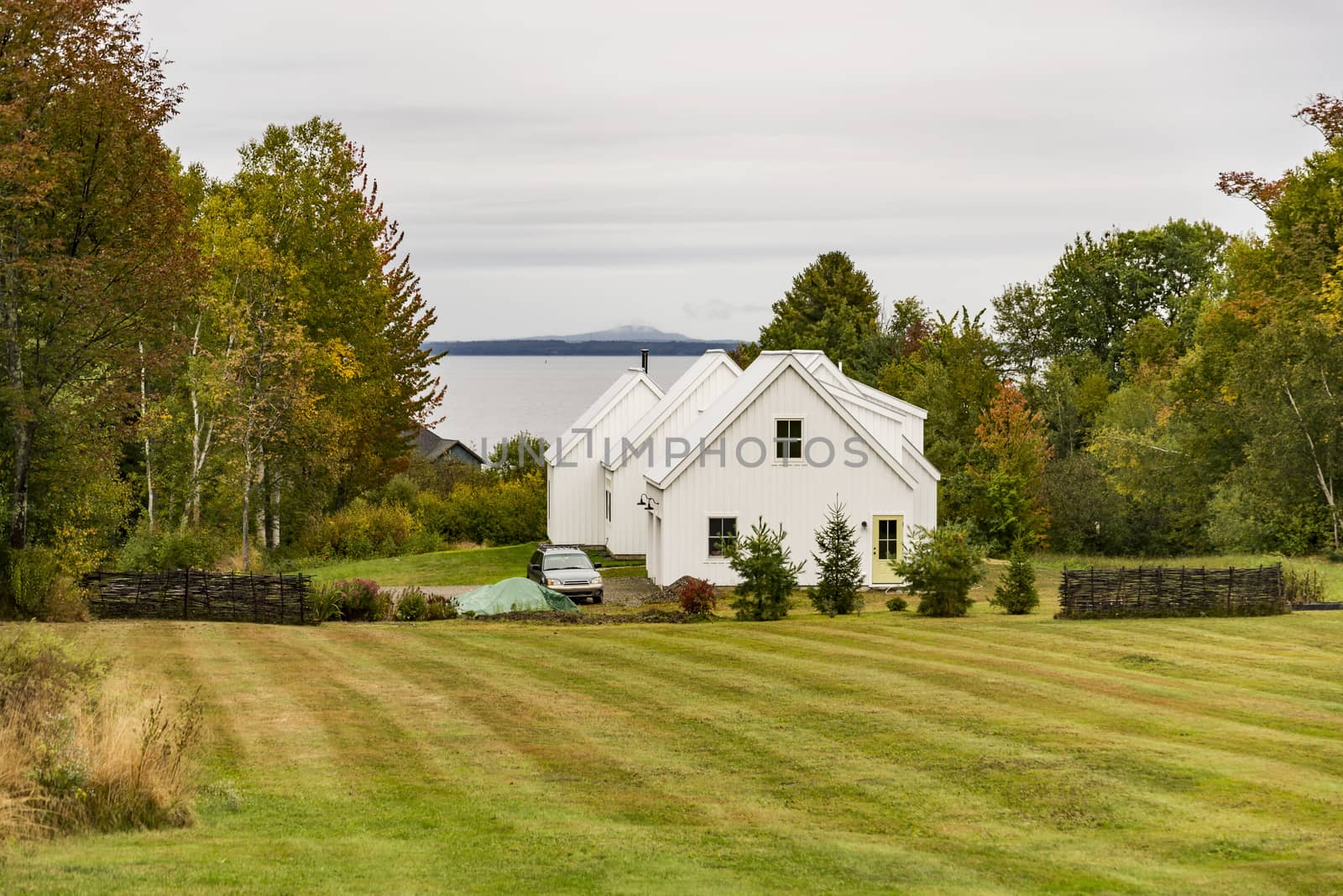 New England traditional house in the fall by edella