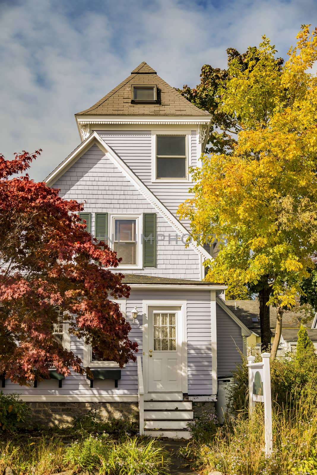 New England traditional house in the fall by edella