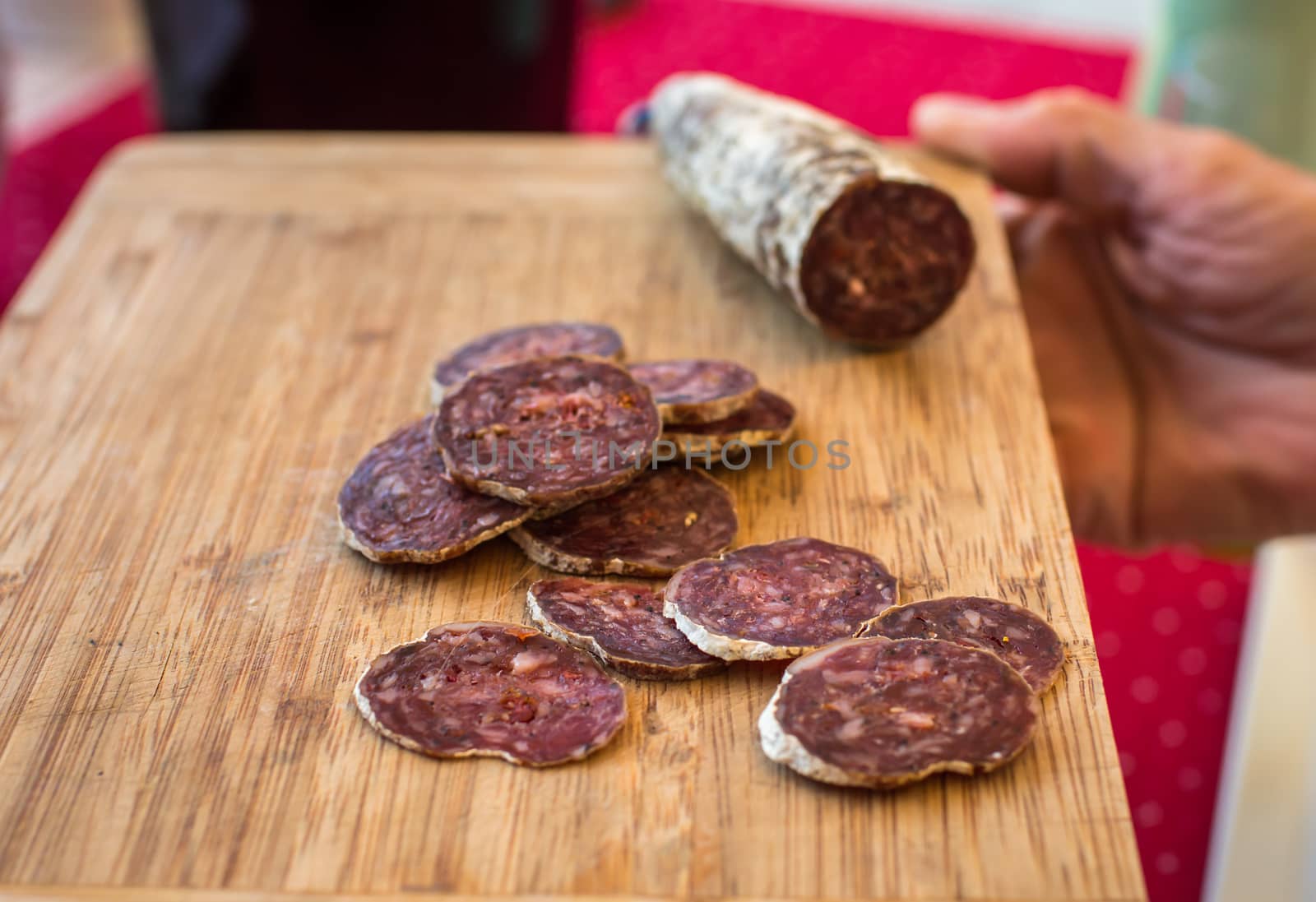 sliced sausage on a wooden board on the table