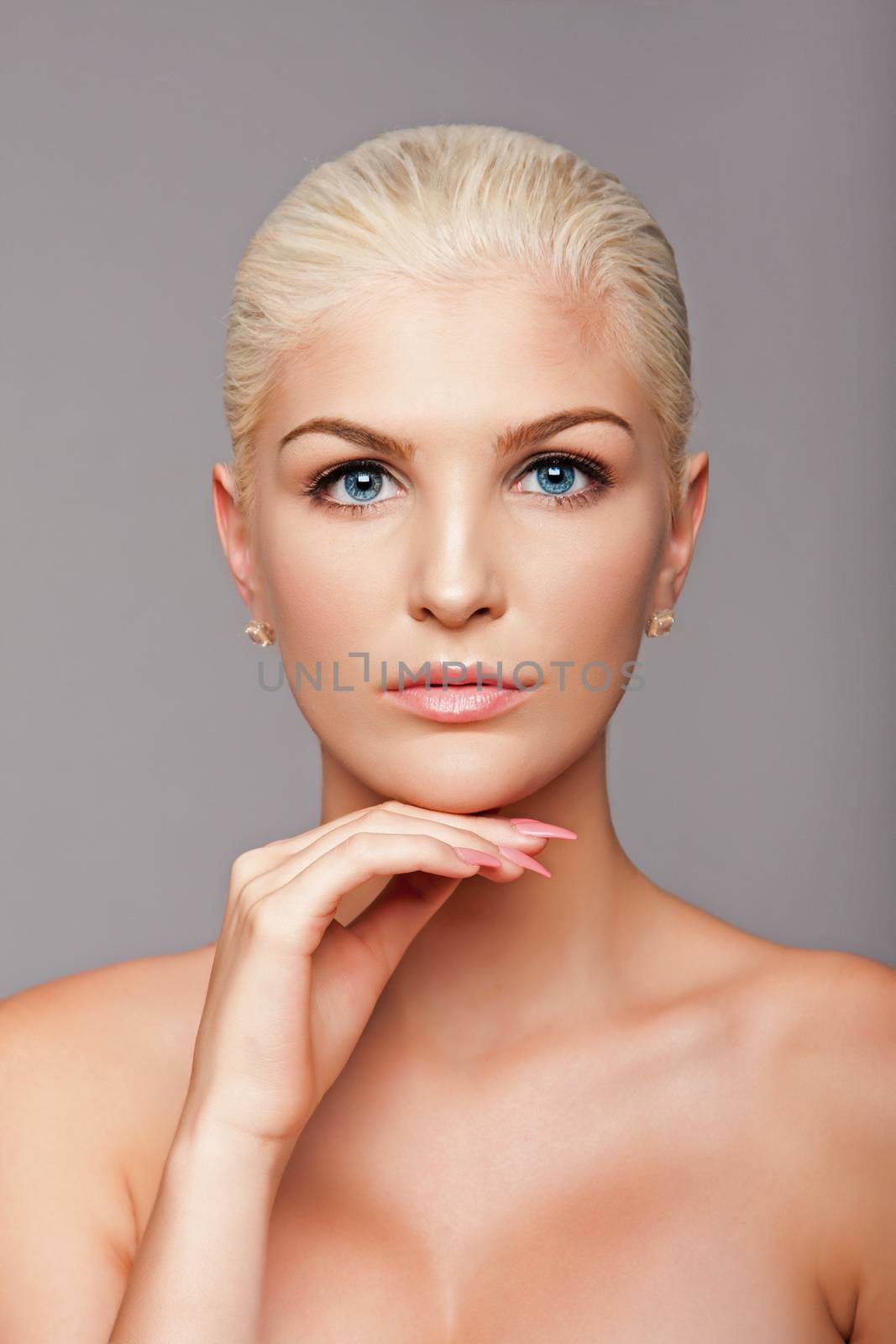 Beauty portrait face of beautiful blond woman with blue eyes and smooth skin, aesthetics skincare concept.