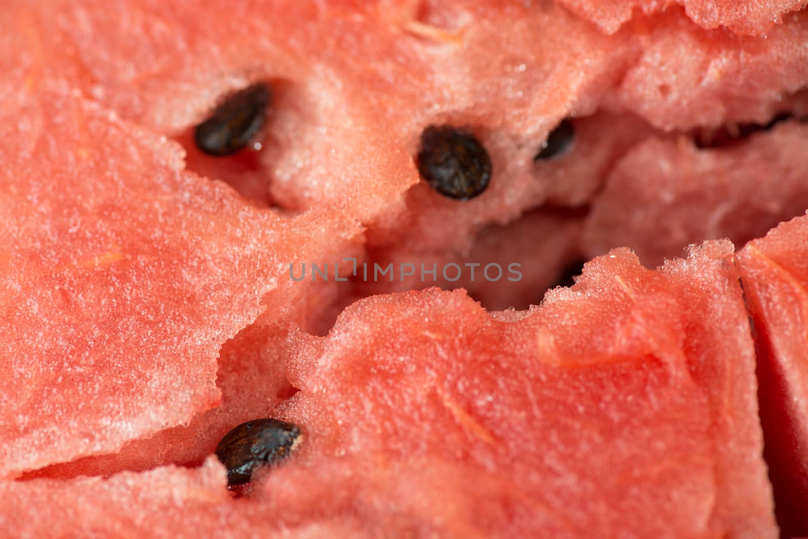 ripe watermelon flesh closeup macro texture background.