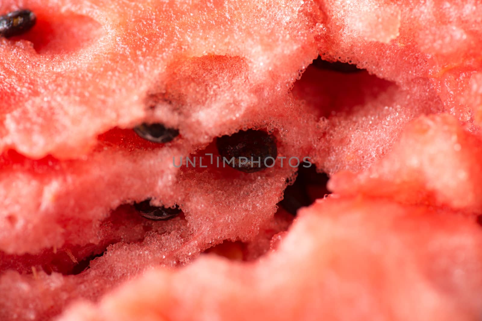 ripe watermelon flesh closeup macro texture background.