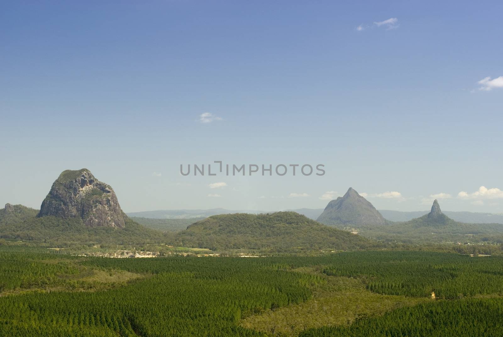 Scenic landscape view of the lush green surroundings and topography of Glass House Mountains on the Sunshine Coast, Queensland , Australia on a sunny blue sky day in a travel concept