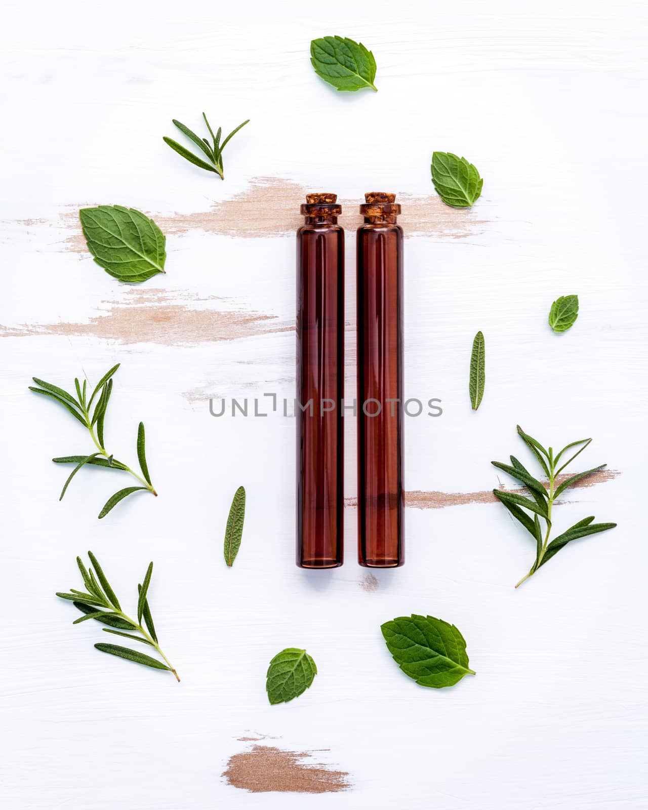 Bottle of essential oil with  fresh herbal  rosemary, thyme and  by kerdkanno