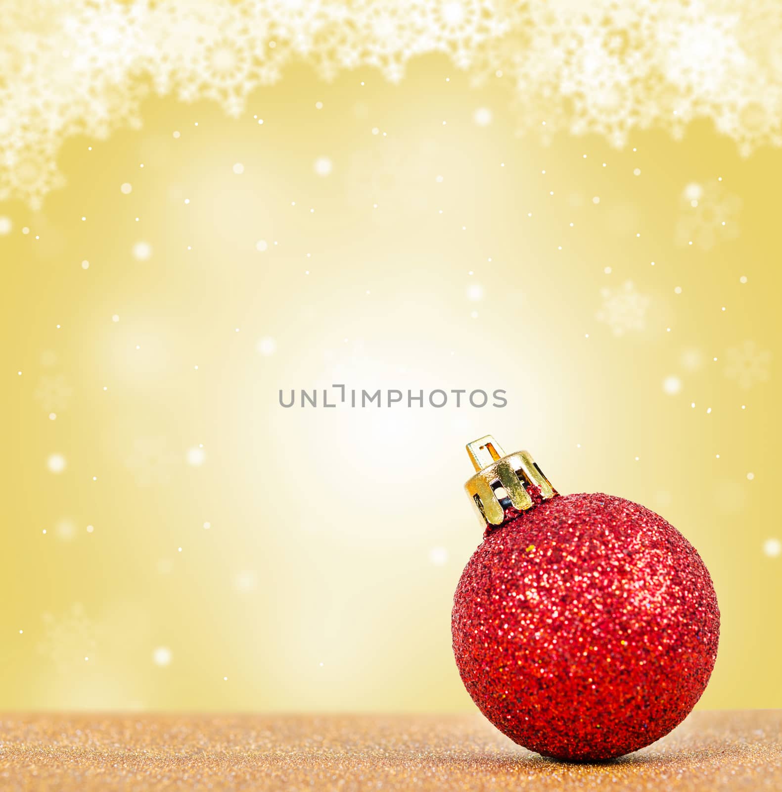 Glitter red ball on christmas yellow background.