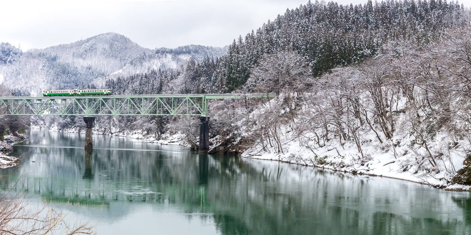 Train in Winter landscape snow on bridge panorama