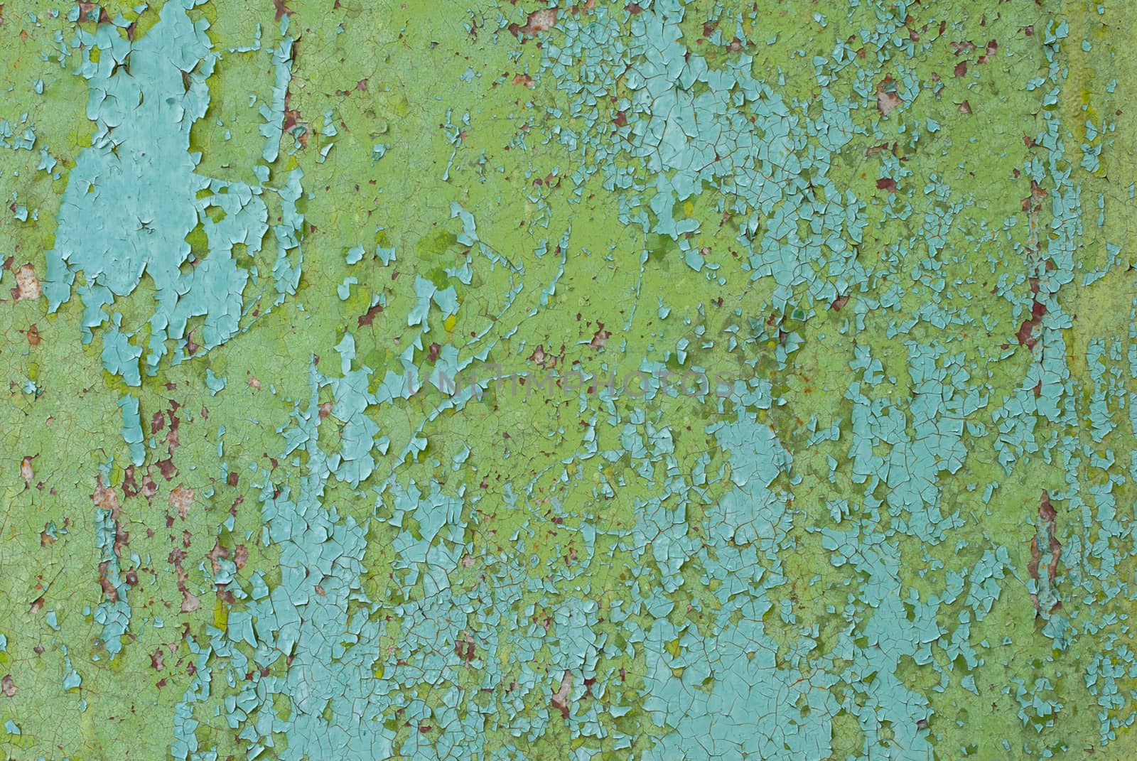 rusty iron surface covered with old chipped paint, which has long been influenced by different climatic conditions