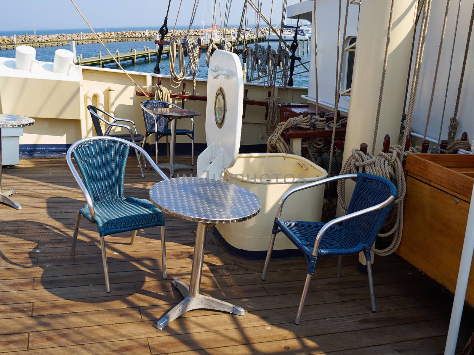 On board deck of a moored old traditional vintage tall ship chairs and coffee table
