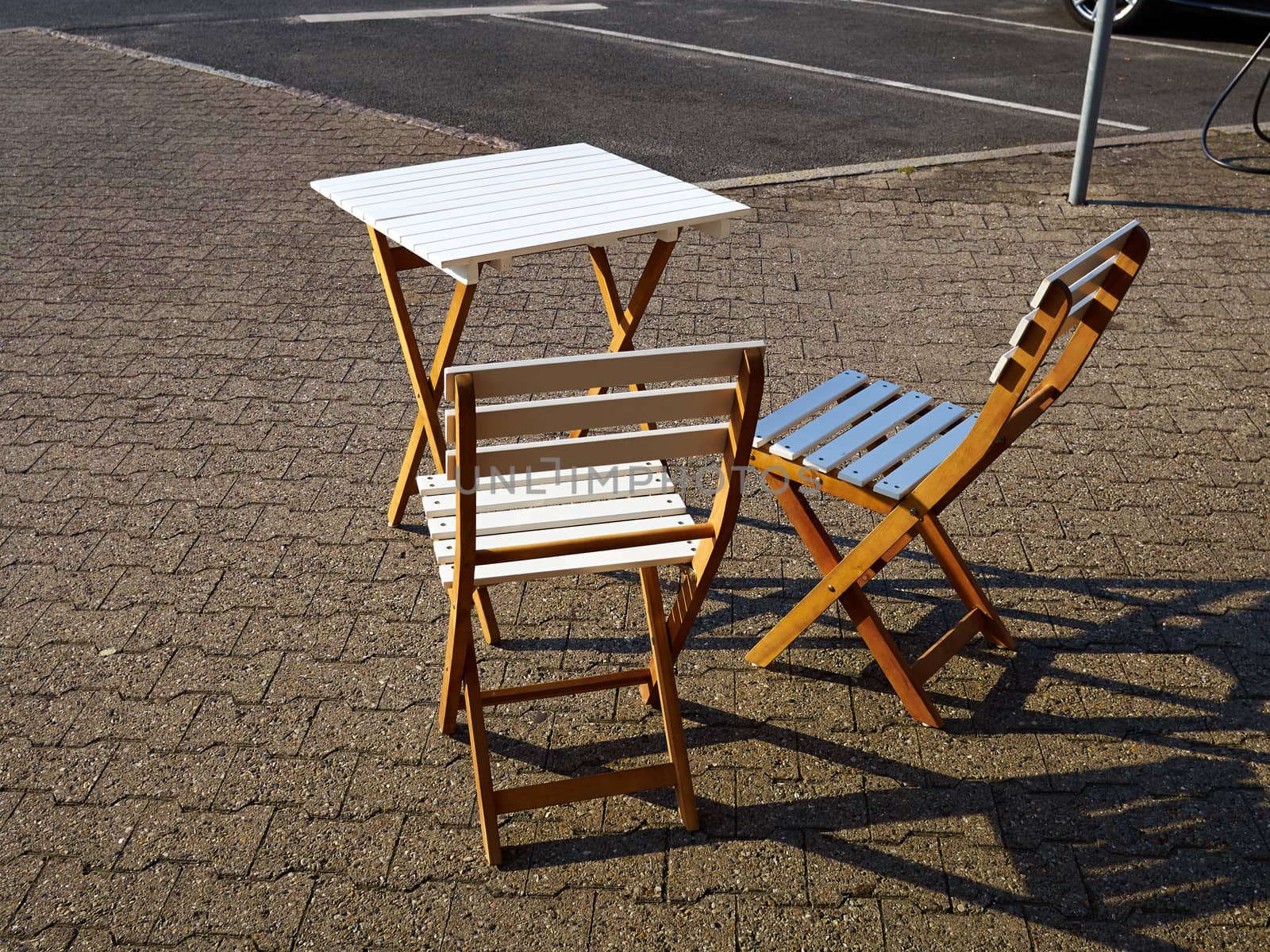 Old classical vintage style wooden coffee table and chairs in a street