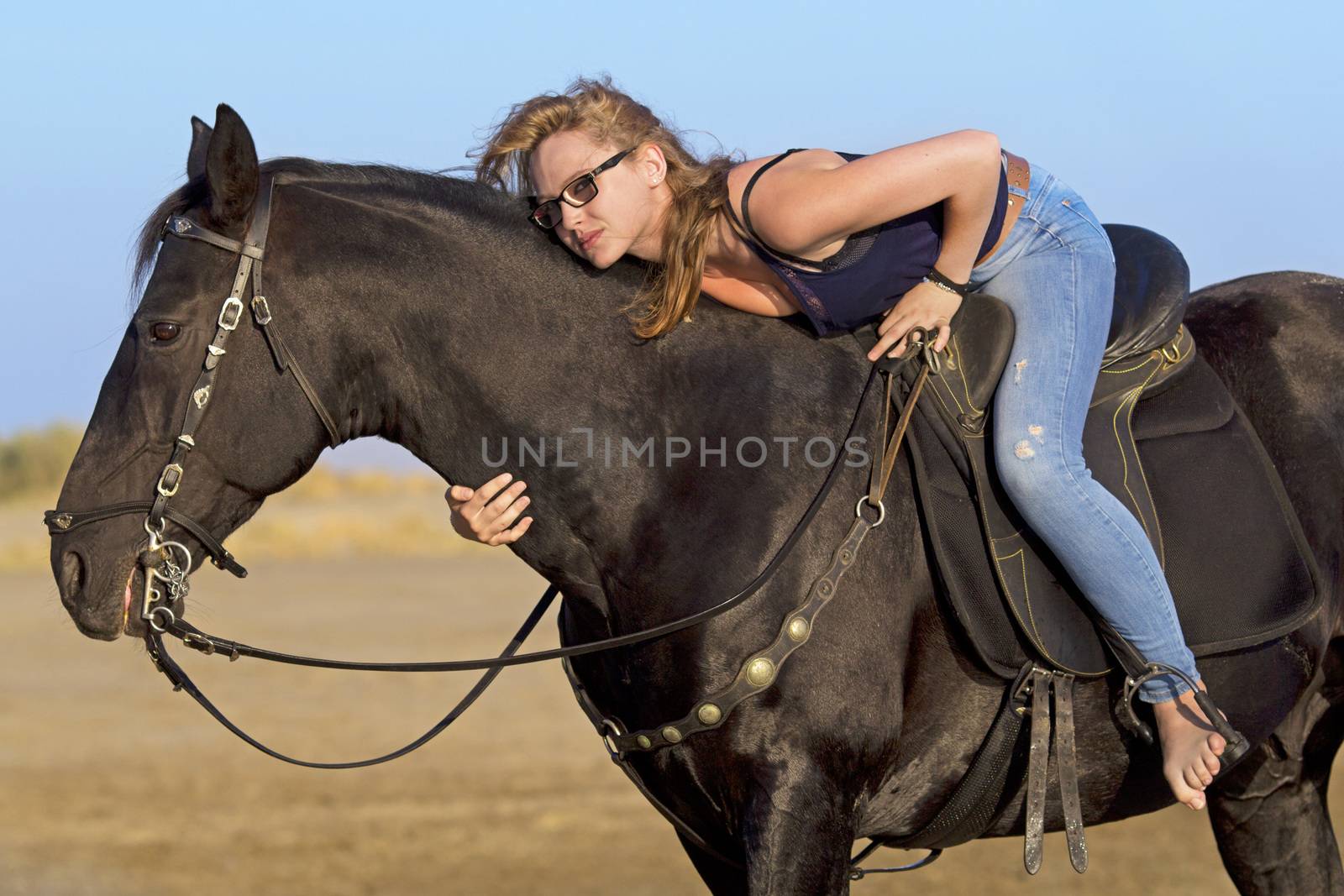 horsewoman and her horse on the beach