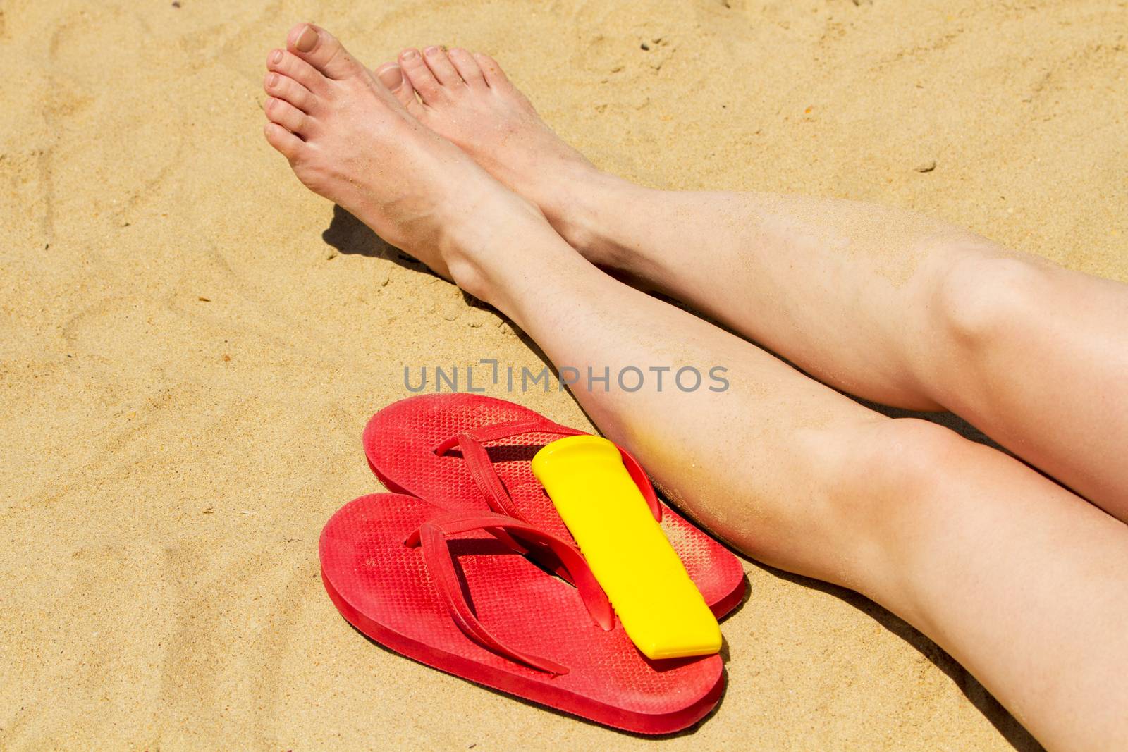Female legs on a sand