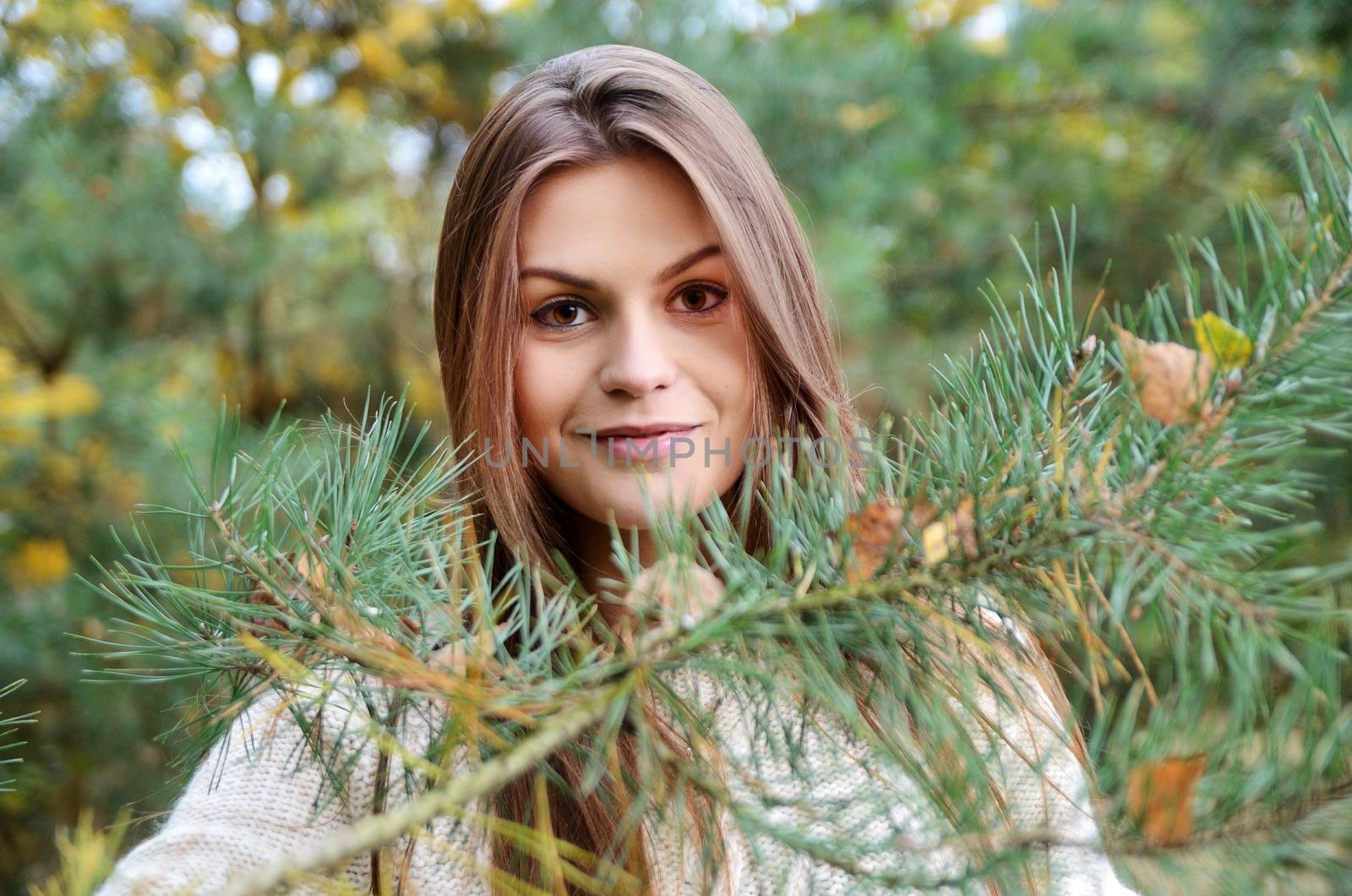 Polish forest with colorful leaves. Portrait of young female model with autumn scenery. 