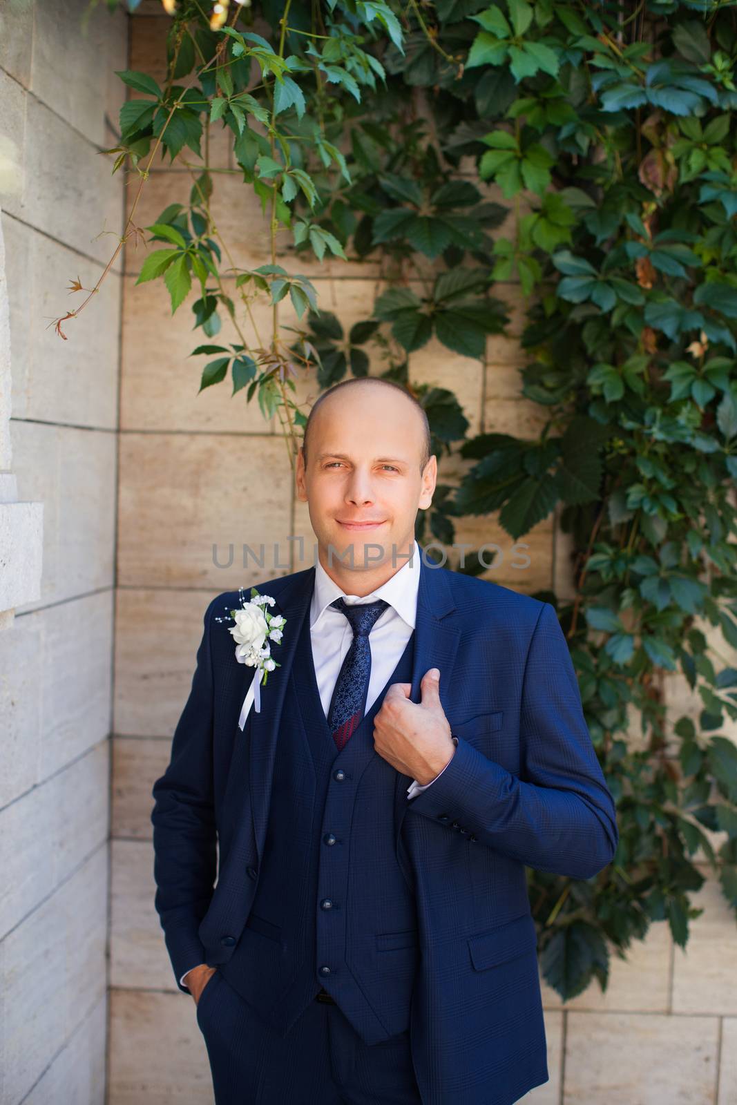 The groom in a blue suit with  vest by lanser314