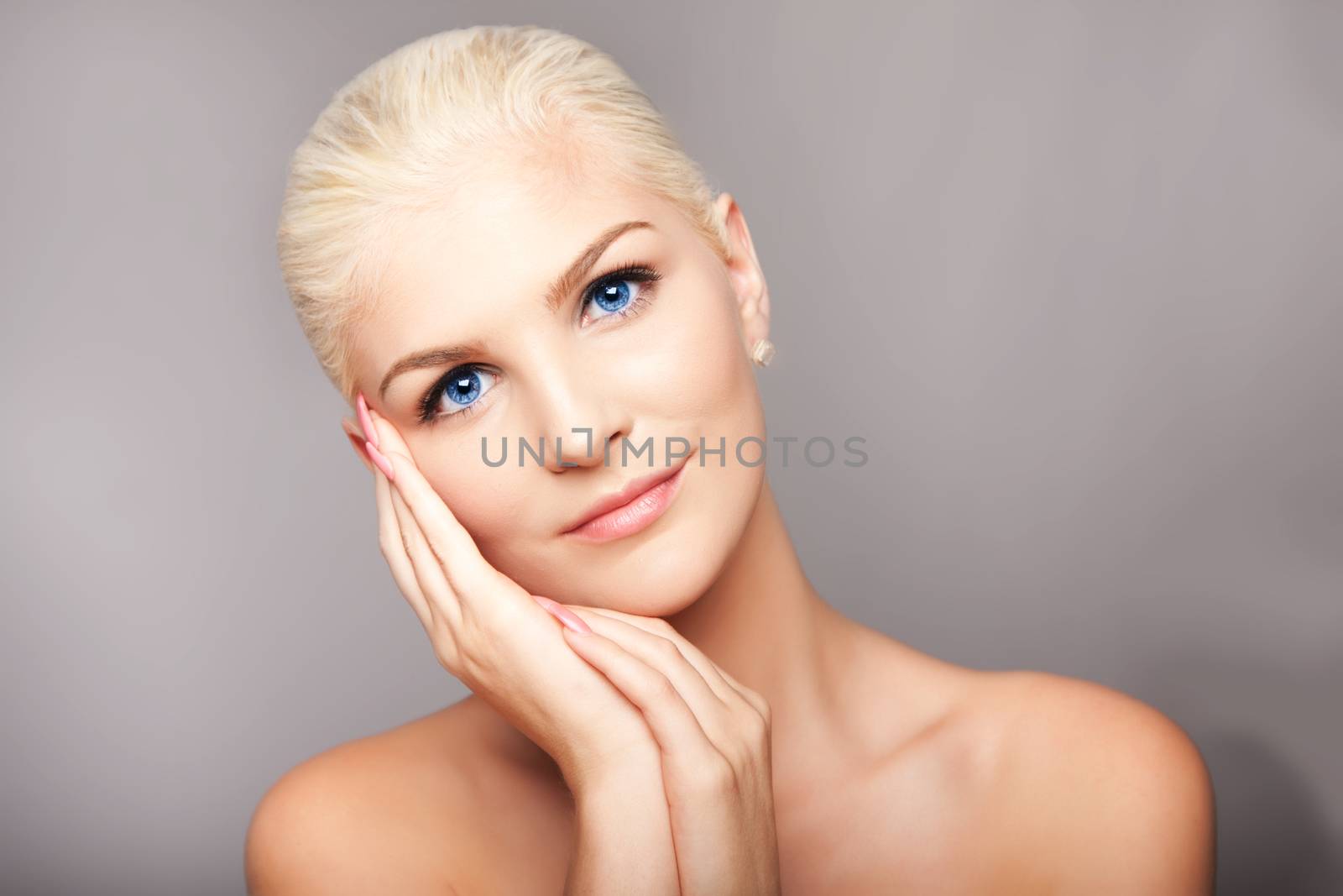 Beauty portrait face of beautiful blond woman with blue eyes and smooth skin, aesthetics skincare concept.