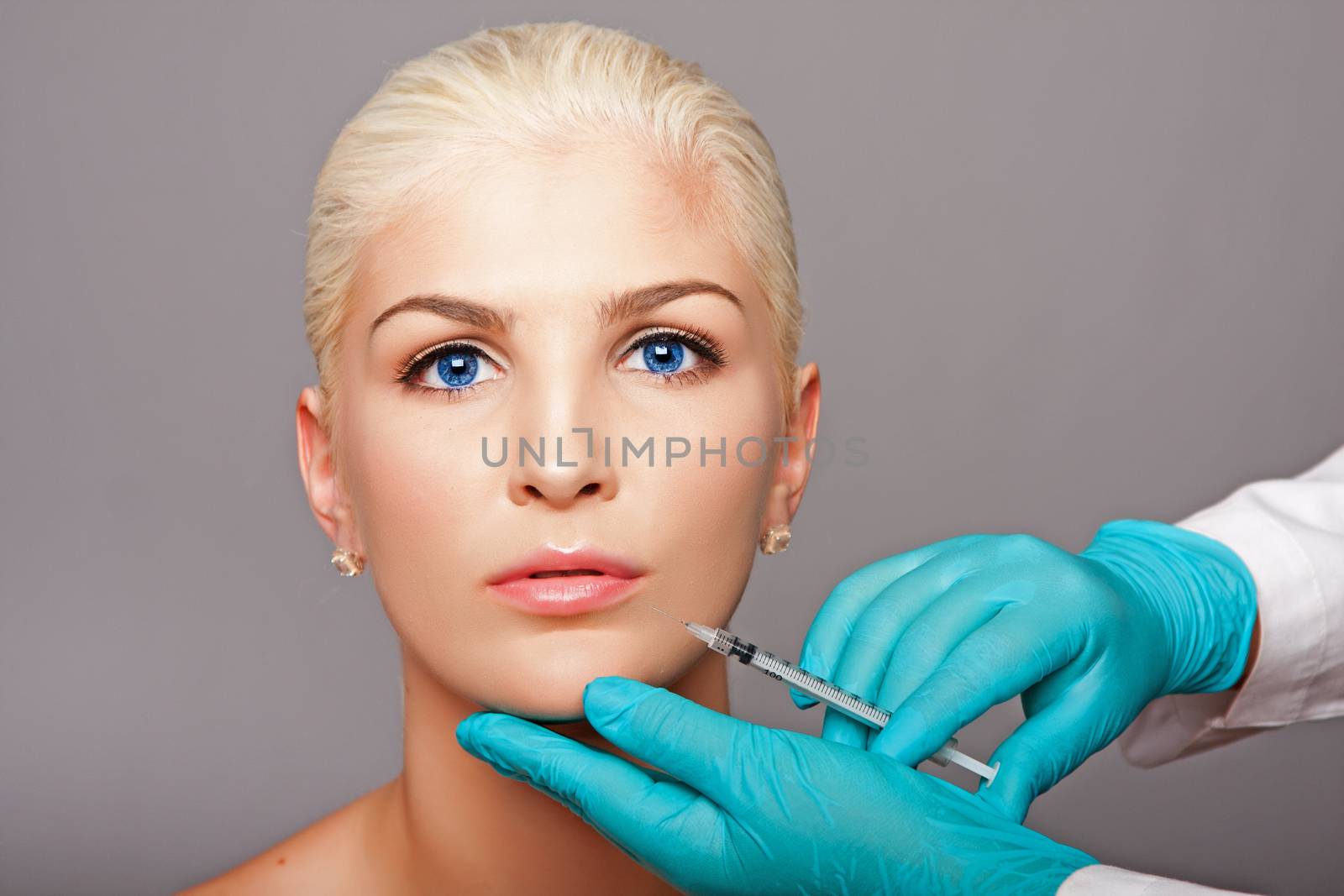 Cosmetic plastic surgeon injecting aesthetics face by phakimata