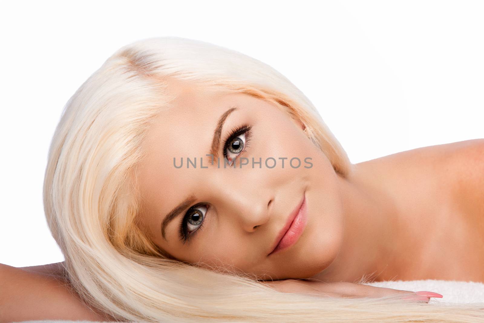 Beautiful face of young woman for Aesthetics facial skincare concept laying on side, on white.