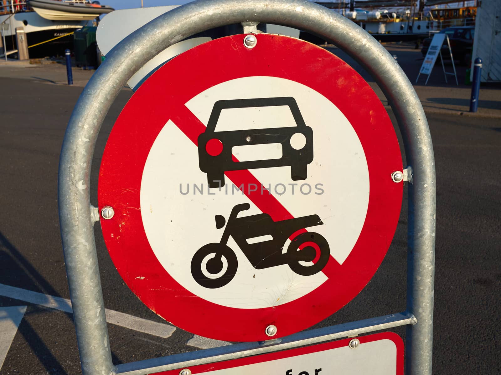 Prohibitory traffic sign the passage of  motorcycles scooters and cars prohibited    