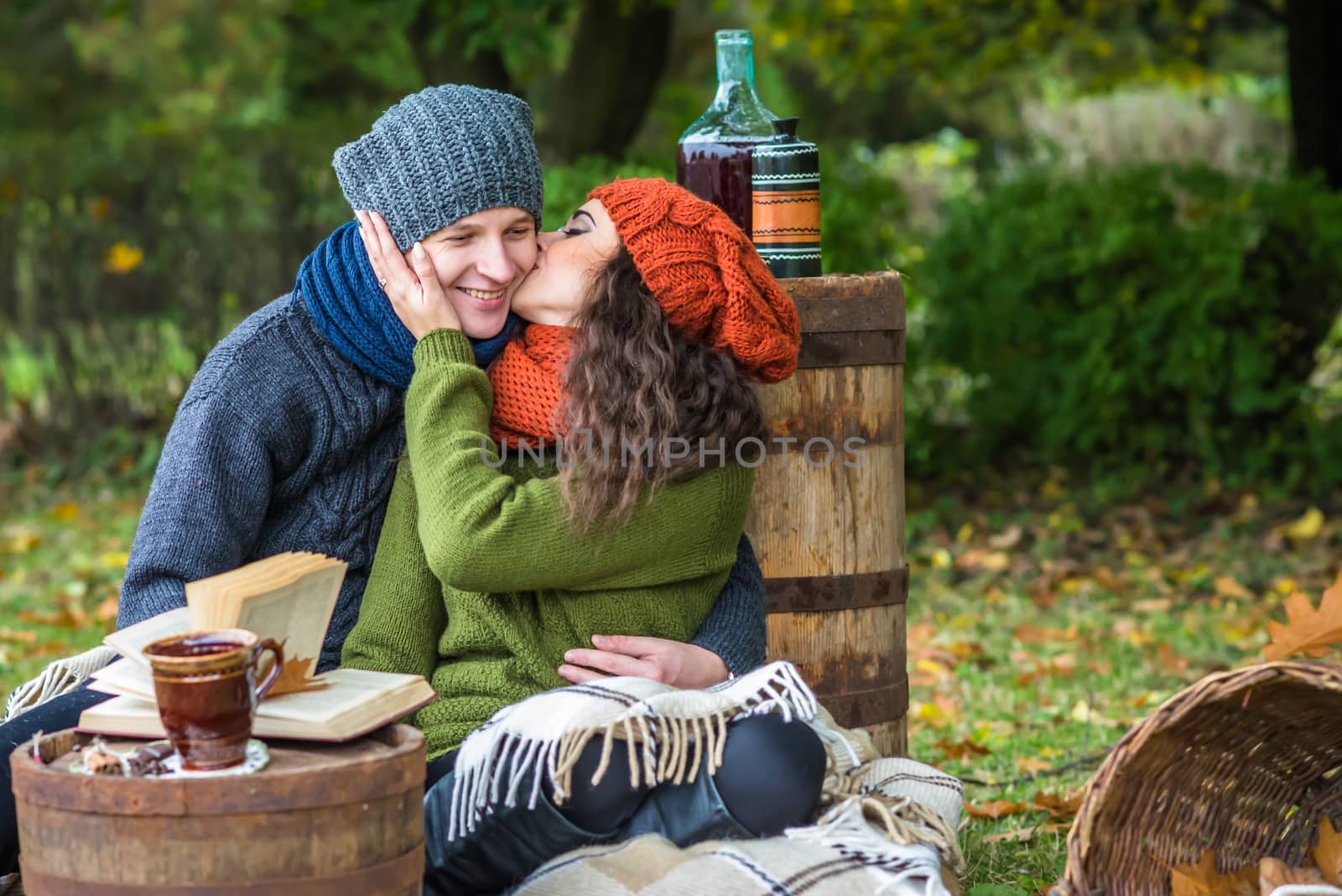 Romantic happy couple at fall couple kissing in autumn garden