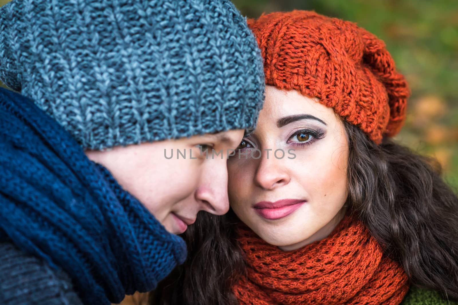 Closeup portrait of a stylish and romantic happy couple at fall in autumn garden