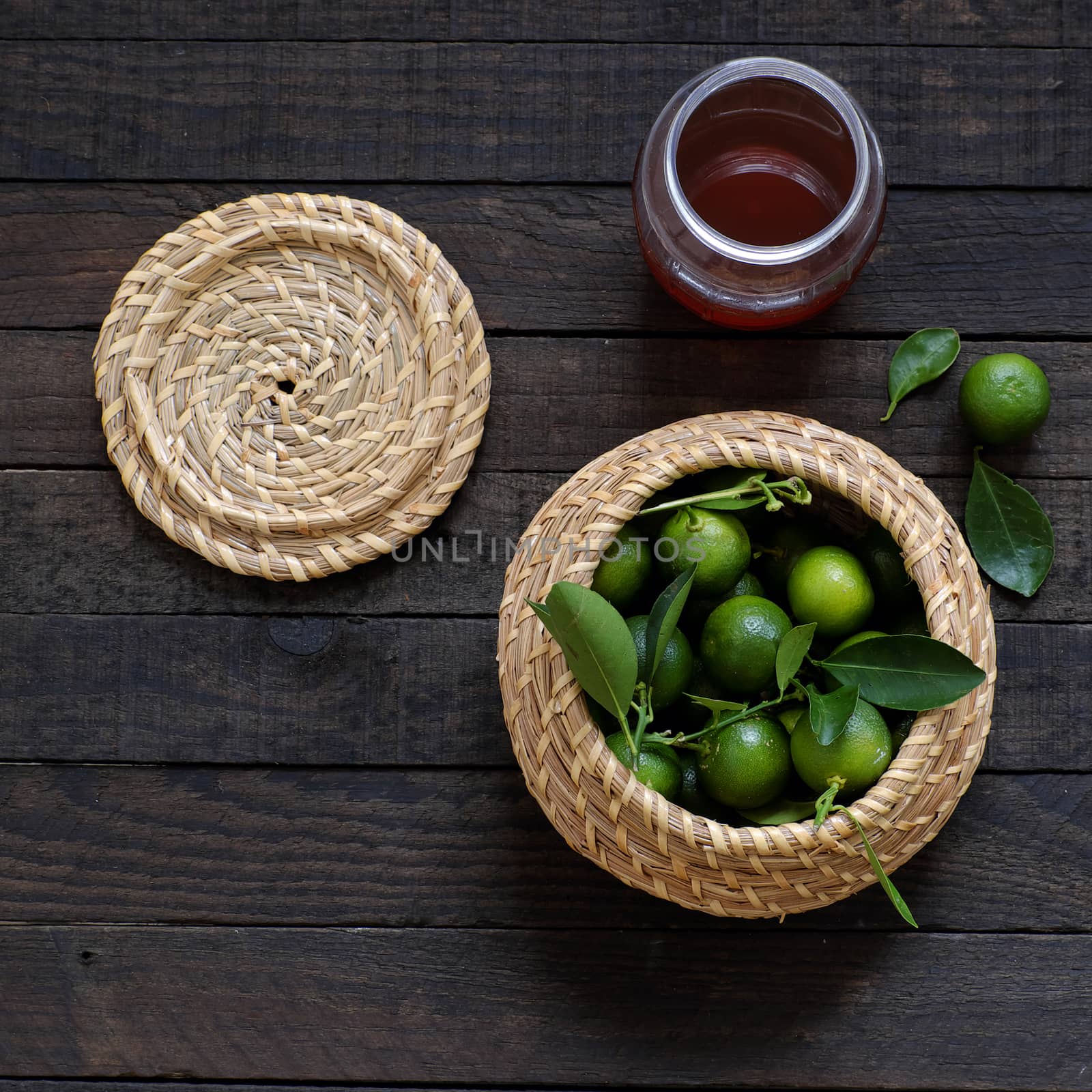 Green Kumquat fruit on wooden background, a popular agriculture product of Vietnam, rich vitamin c, healthy fruit