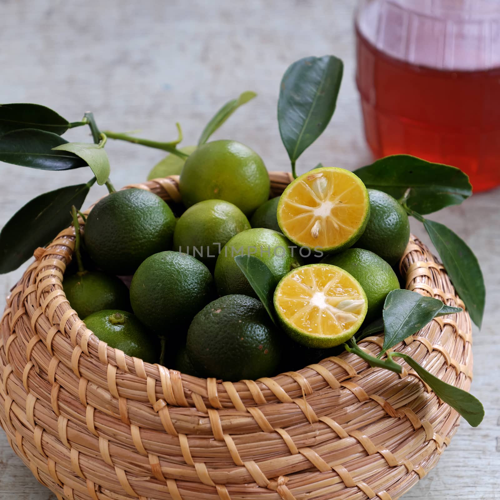 Green Kumquat fruit on wooden background by xuanhuongho