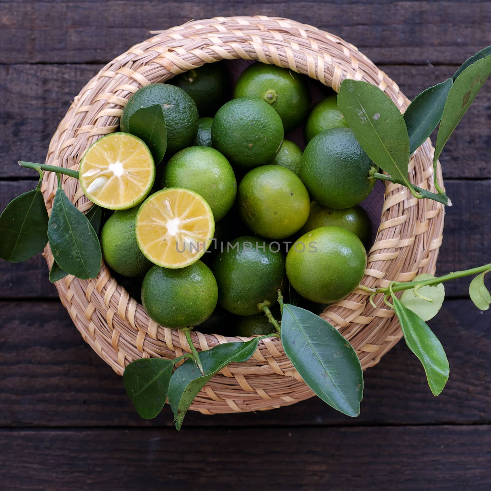 Green Kumquat fruit on wooden background, a popular agriculture product of Vietnam, rich vitamin c, healthy fruit