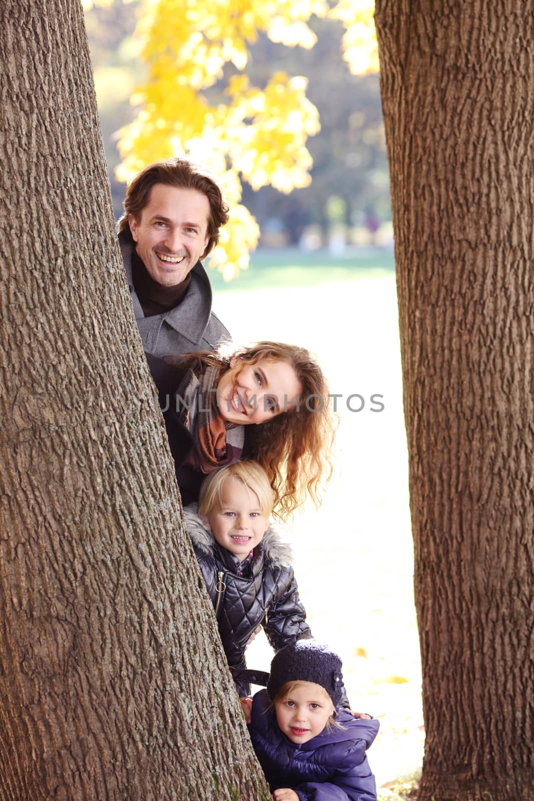 Family in autumn park by ALotOfPeople