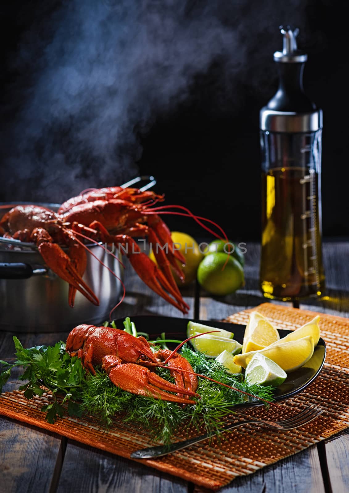 Boiled crayfish with greens and a citrus on a table from old boards