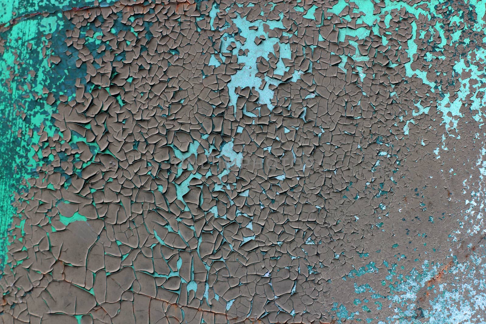 Tatter of a multi-colored old paint on a surface of a stone wall