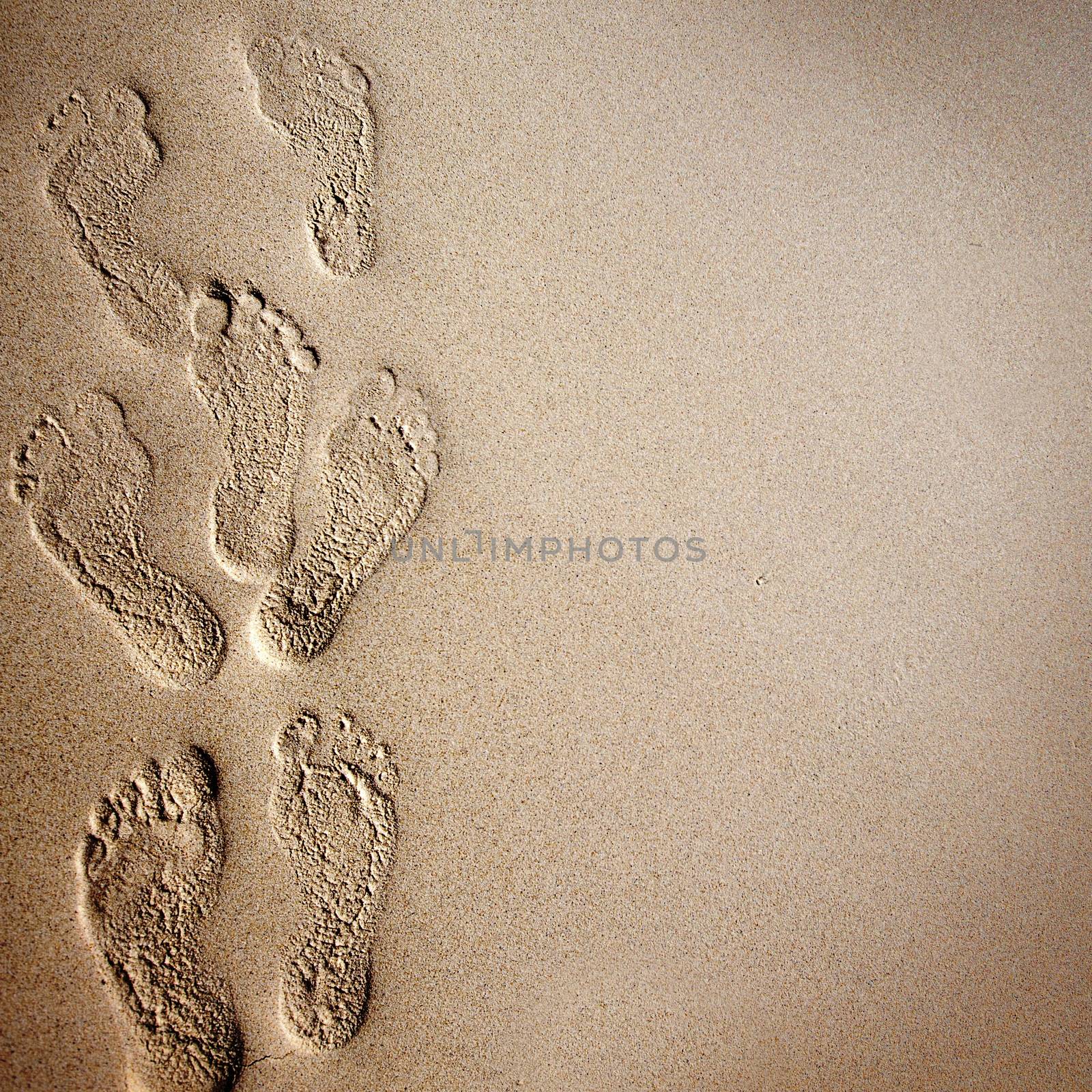 Beach background with footprints in the sand