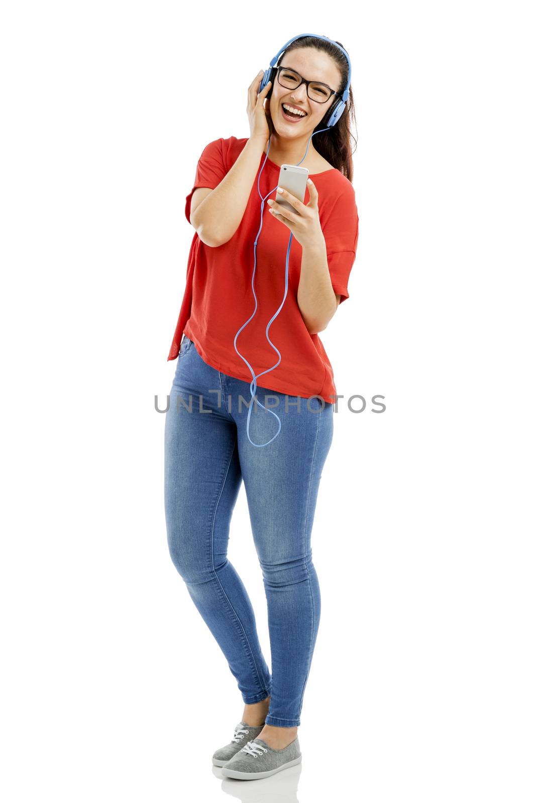 Happy woman listen music on her phone, isolated over white background 