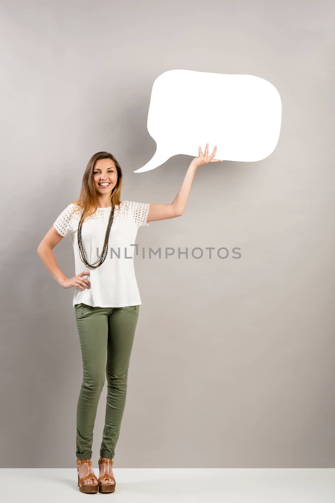 Beautiful woman holding a speech bubble