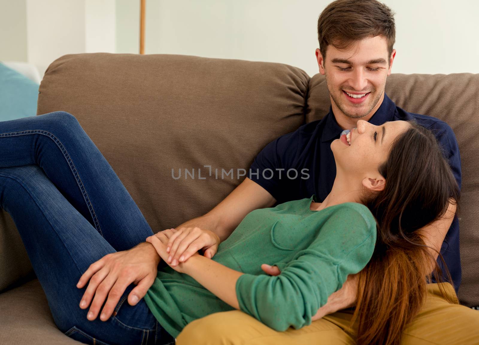 Young couple sitting on the sofa and dating