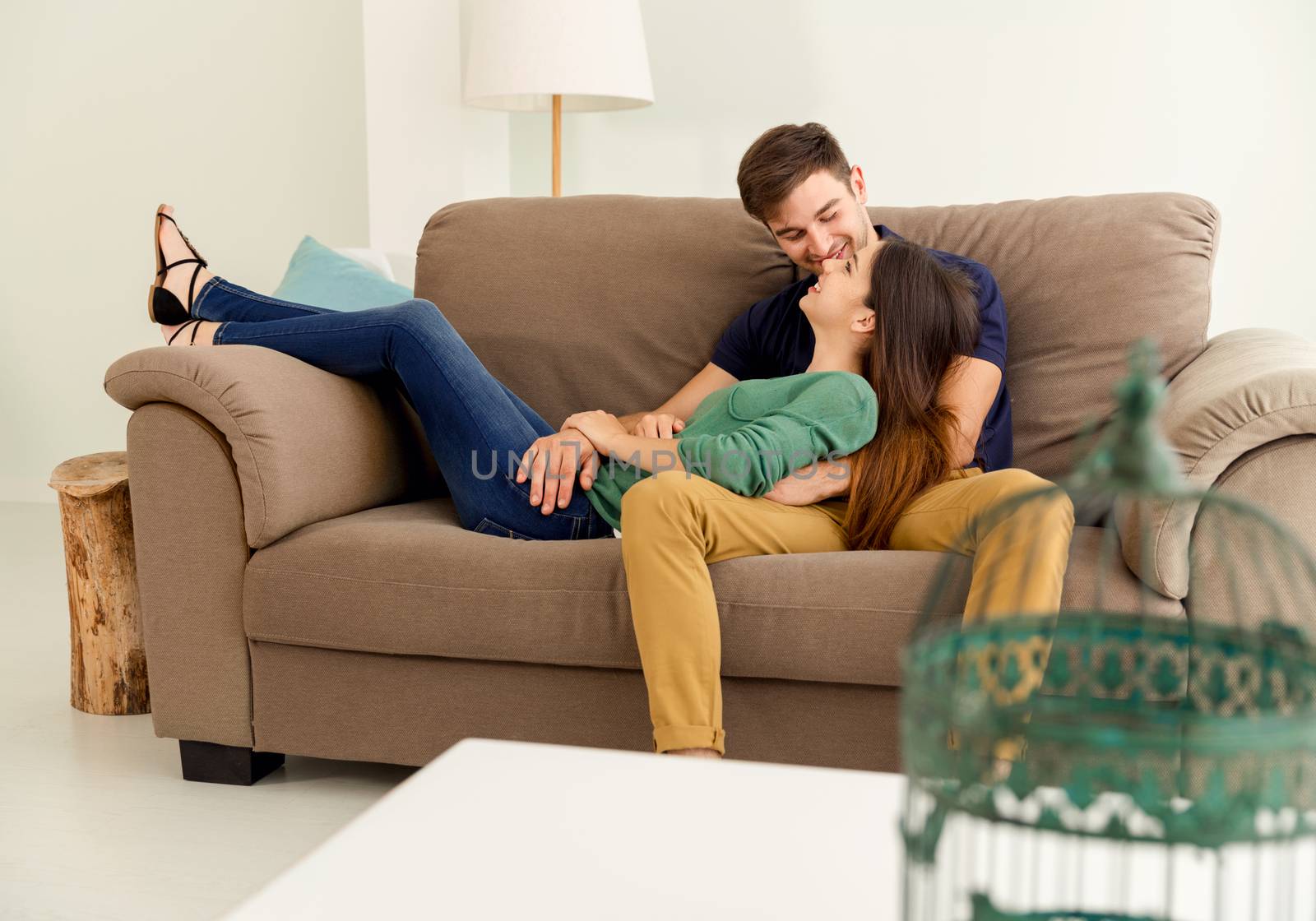 Young couple sitting on the sofa and dating