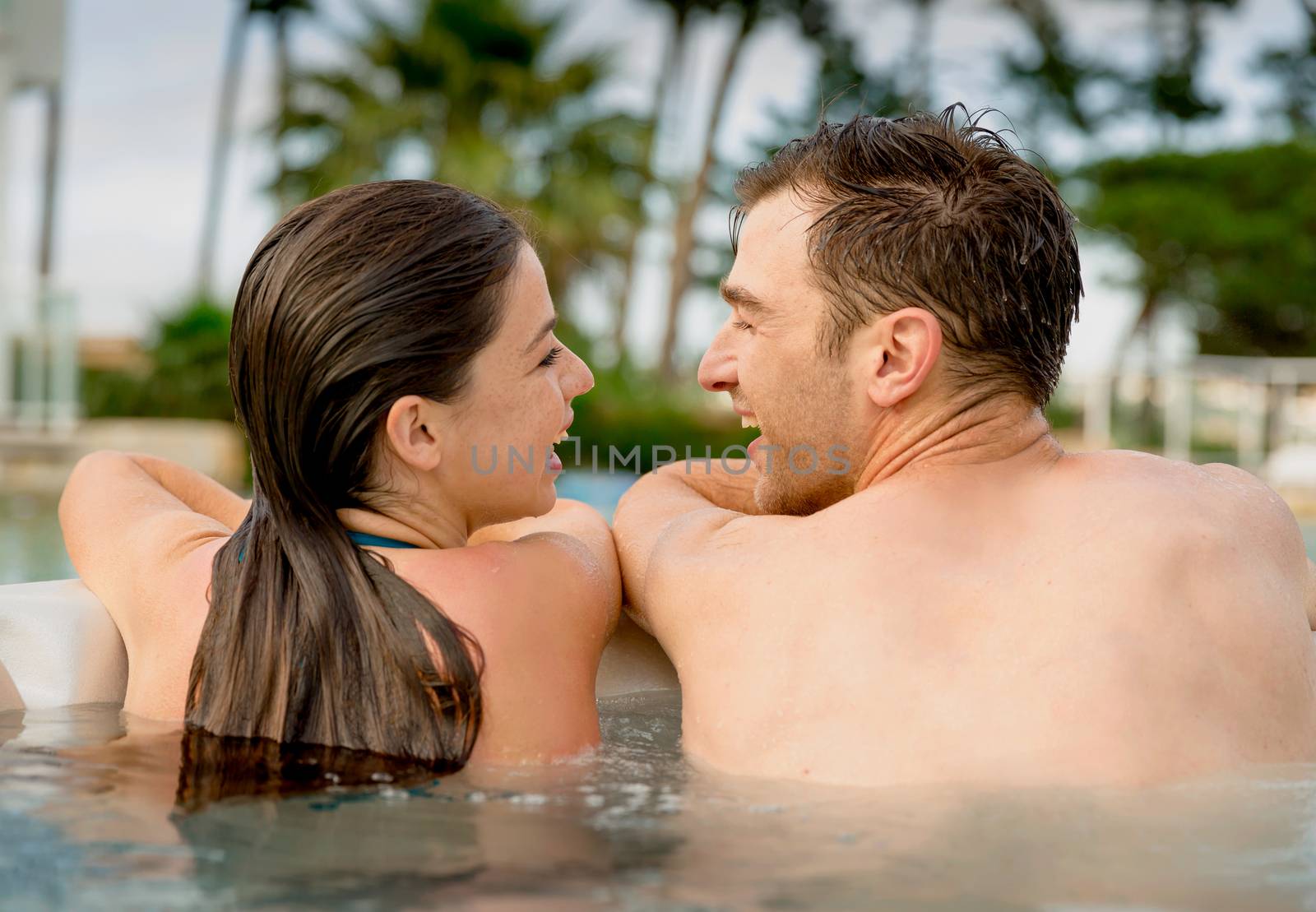 Young couple in a jacuzzi by Iko