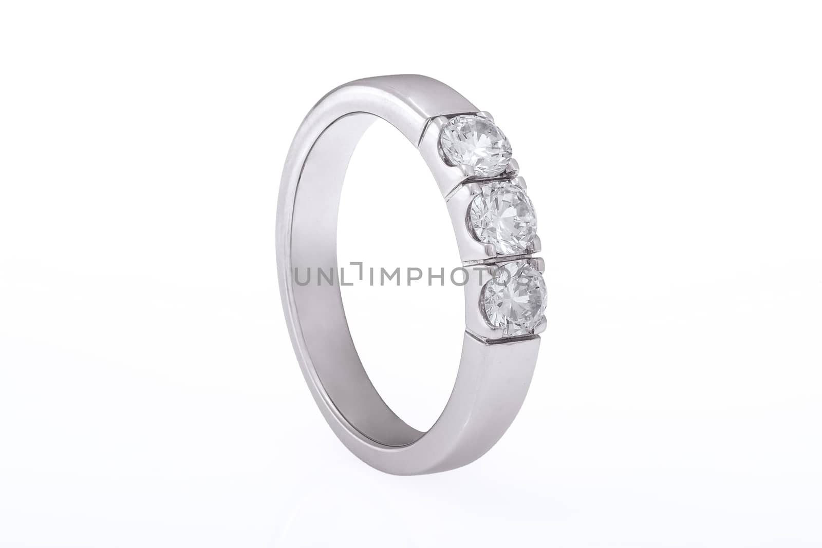 White gold wedding, engagement ring with diamonds on white background