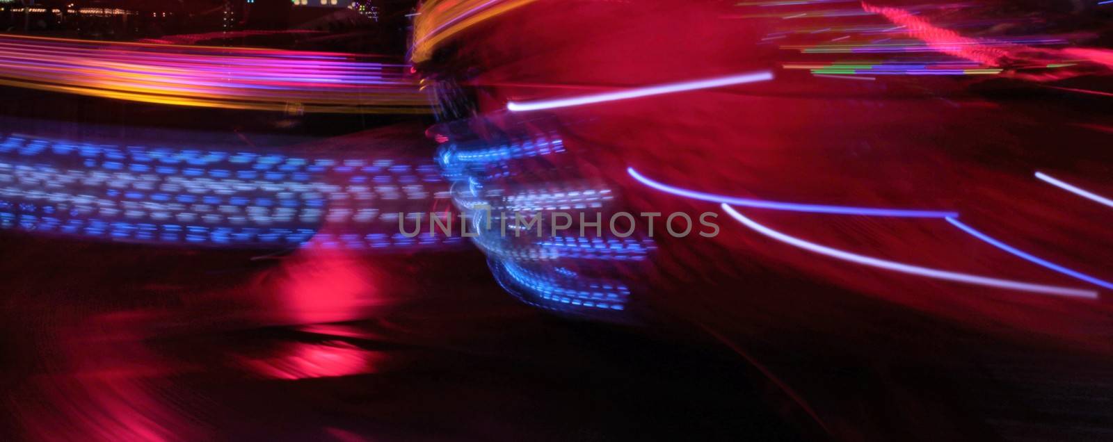 Night colors of the amusement park lights moving, light trails, slow shutter-speed