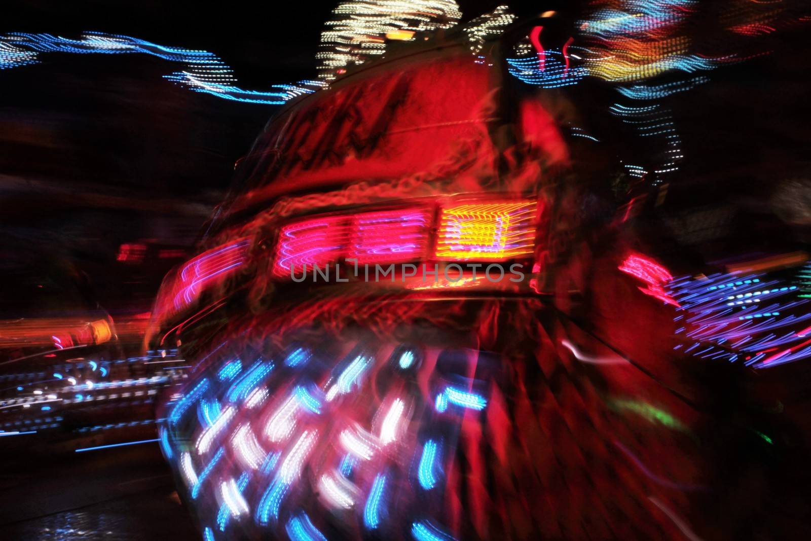 Night colors of the amusement park lights moving, light trails, slow shutter-speed