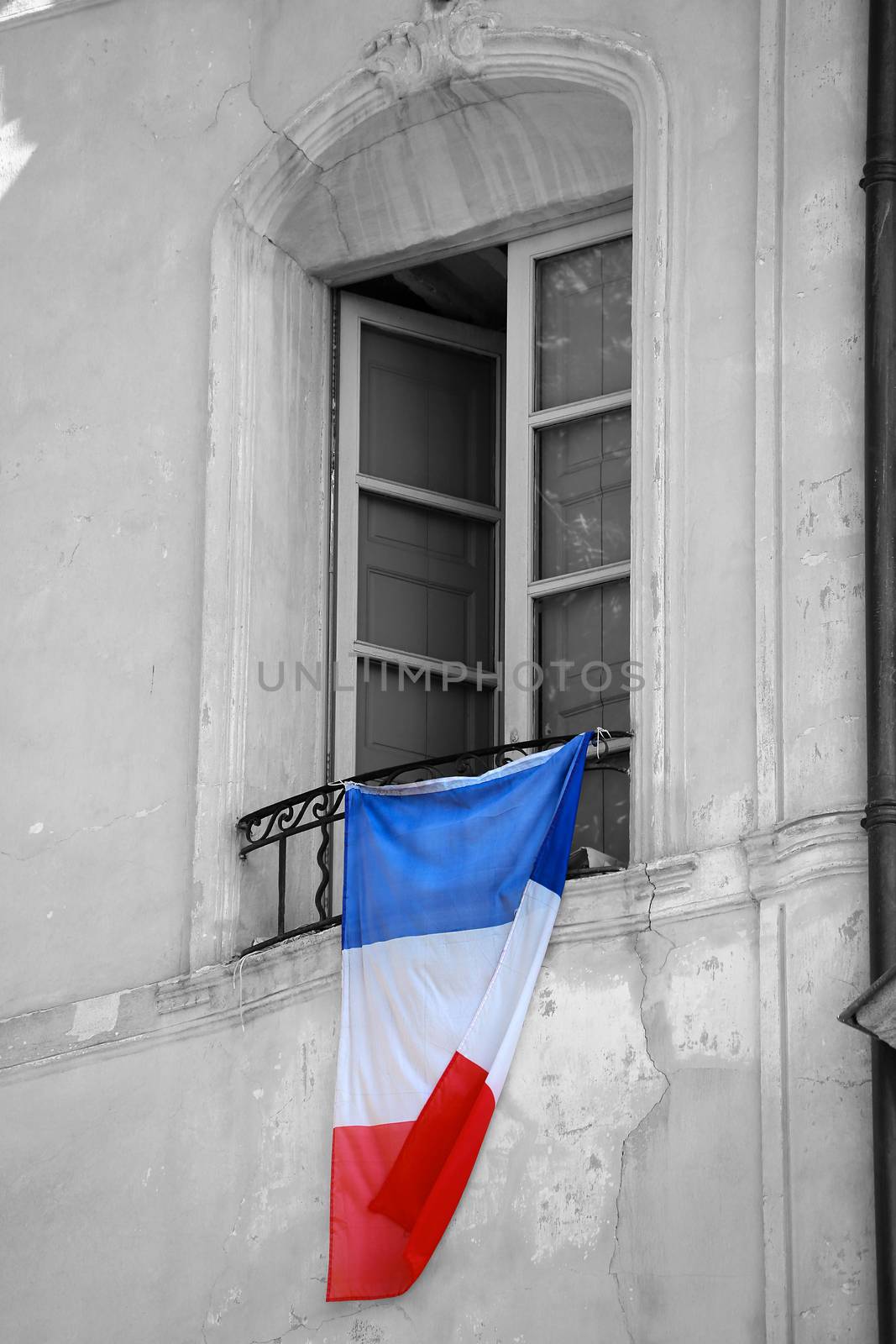 French Flag Hanging on the Window of a Building  by bensib