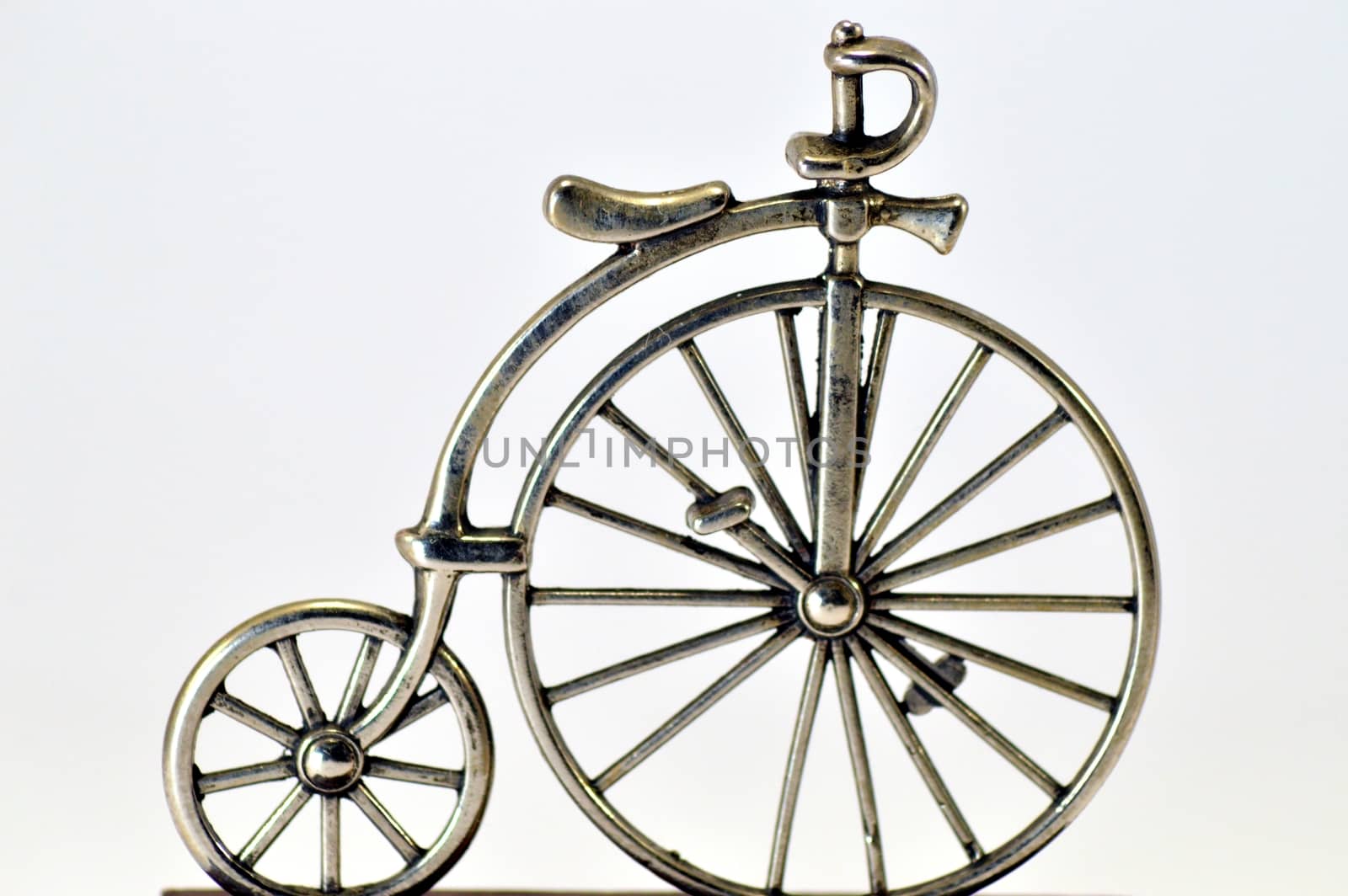 Ancestor of the bike in miniature on a white bottom.