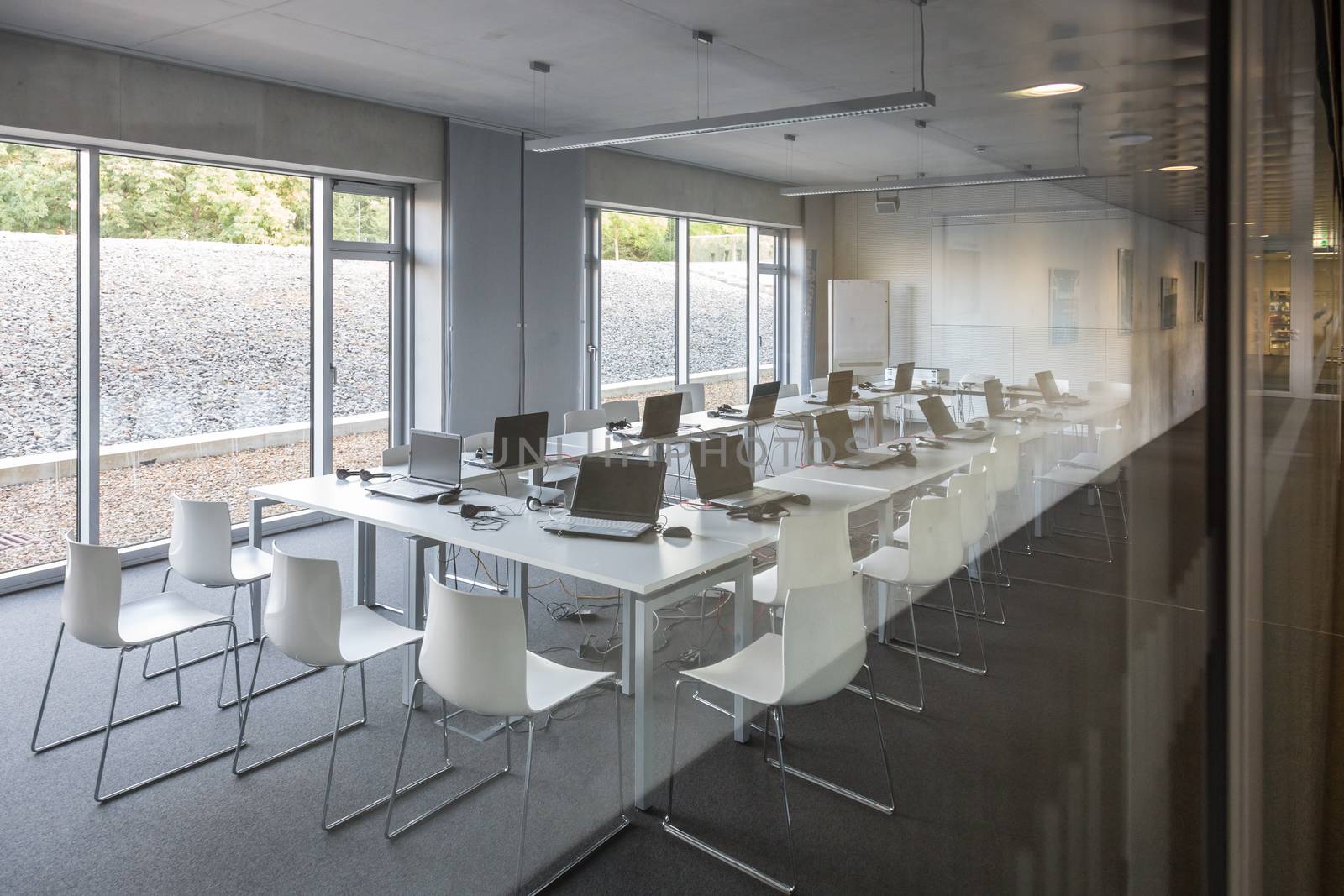Interior of empty contemporary conference hall with white chairs.
