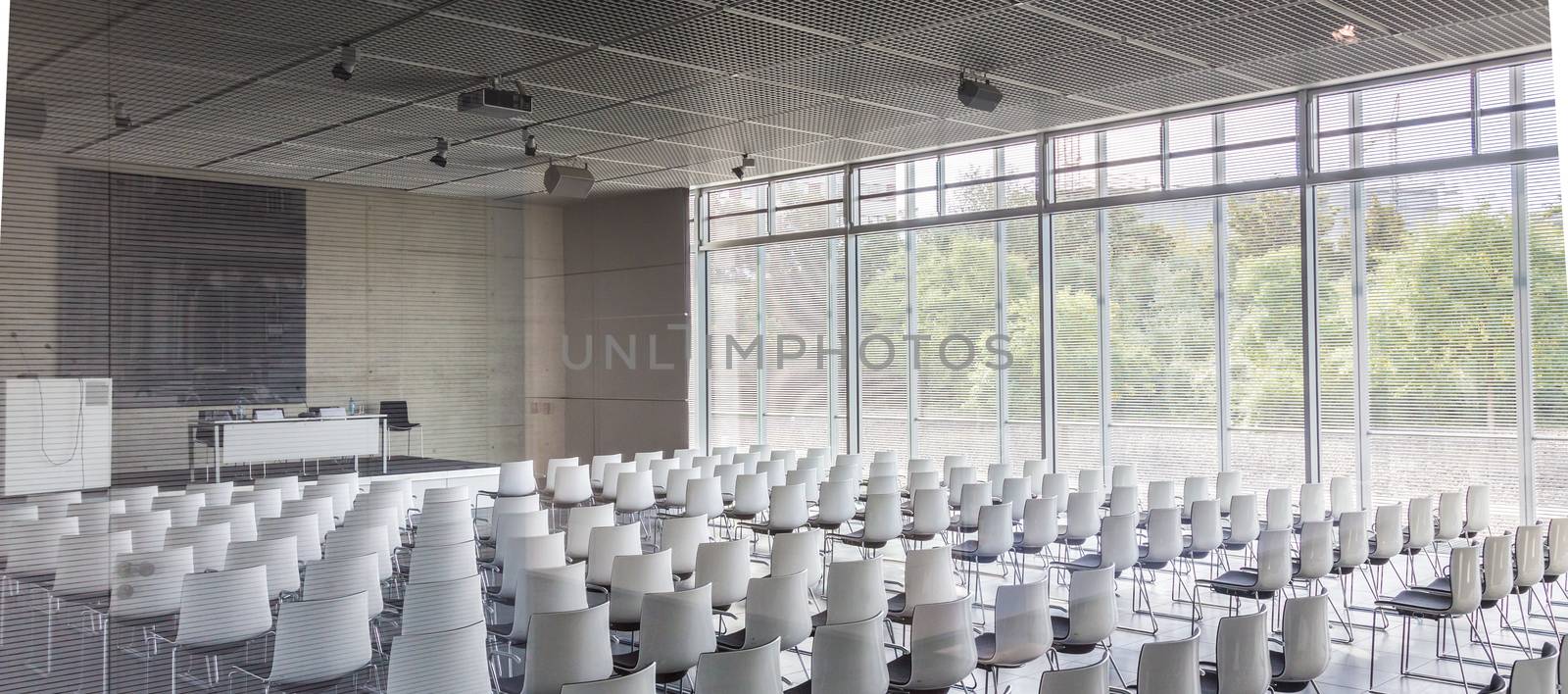 Empty white chairs in contemporary conference hall with by kasto