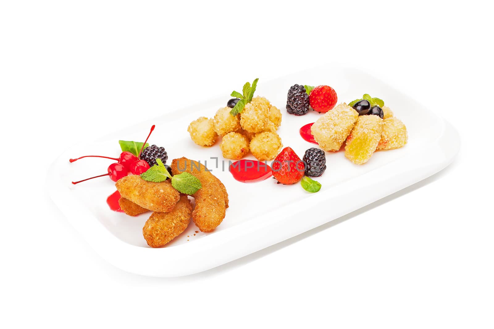 The meat balls and cheese sticks fried in breadcrumbs and served on a white dish, with strawberry, blackberry, bilberry, leaves of mint with cocktail cherries, isolated on a white background.