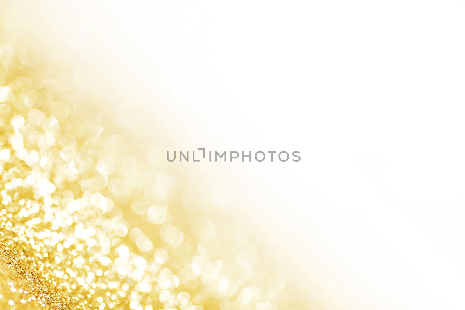 Abstract shining glitters gold holiday bokeh background with white copy space