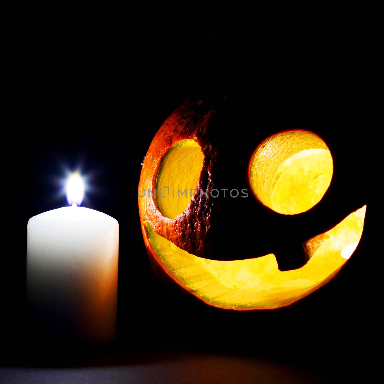 Halloween pumpkin and candles isolated on black background