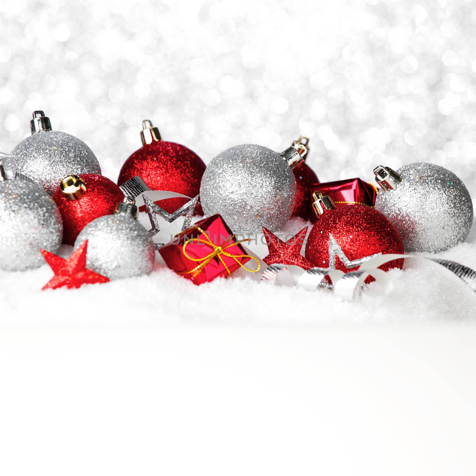 Christmas card with beautiful red and silver decorations in snow